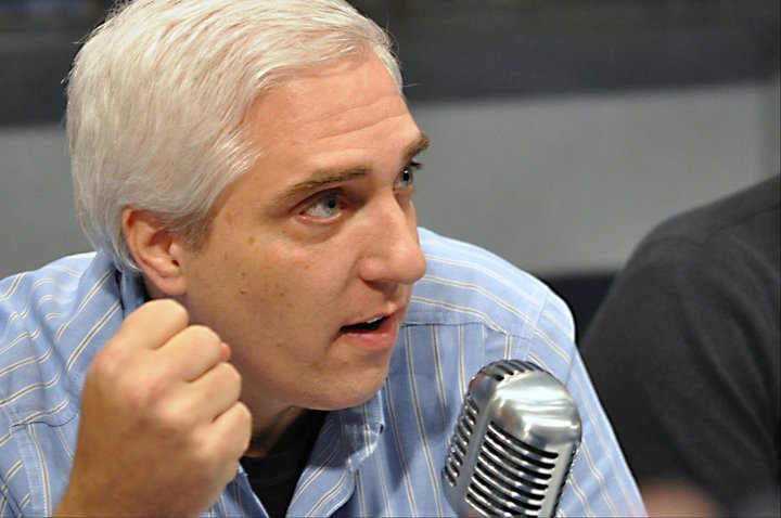 Headshot of Dr. Steven Novella with a microphone